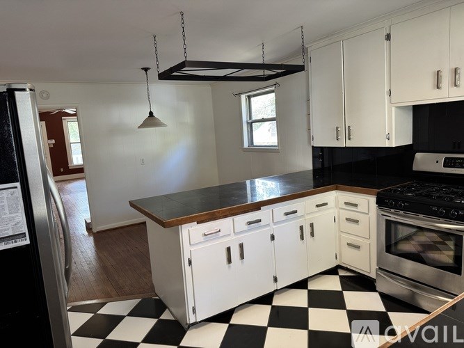 A kitchen with black and white checkered floor.