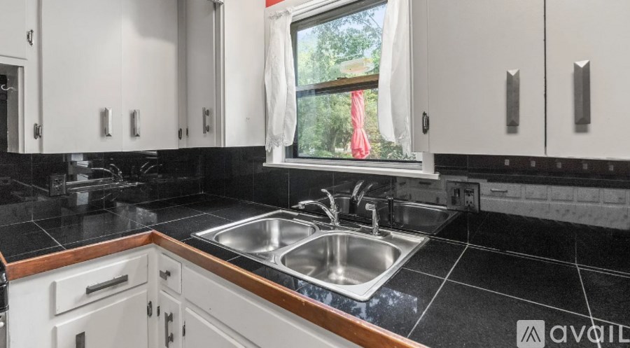 A kitchen with a sink and cabinets.
