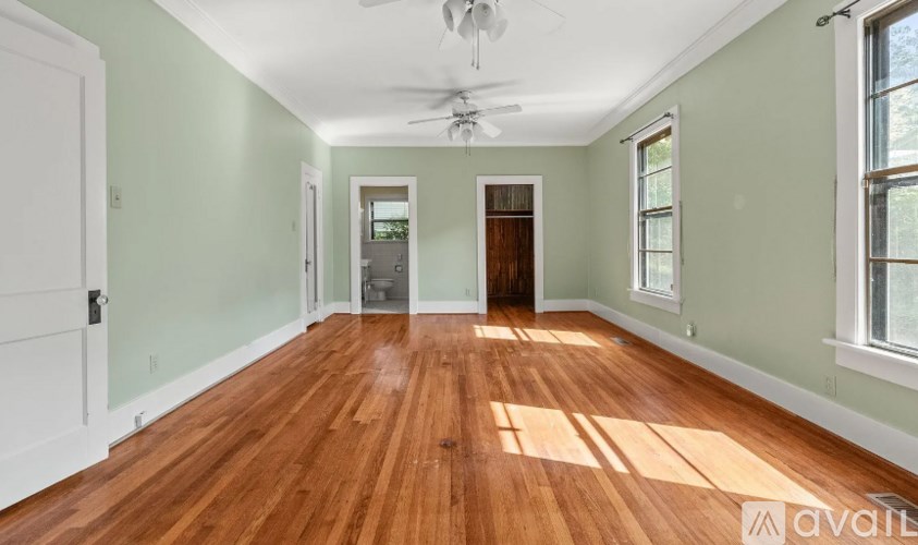 A room with wooden floors and a ceiling fan.