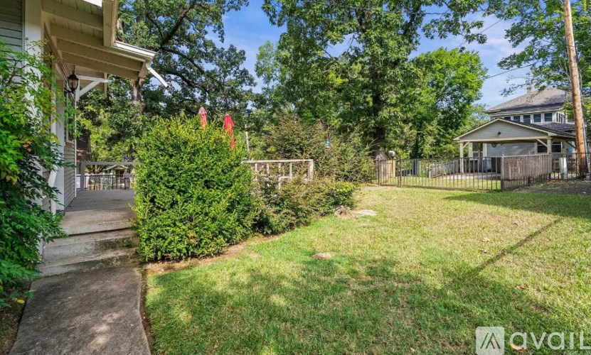 A house with a white porch and a green lawn.