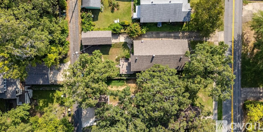 A bird's eye view of a residential area with houses and trees.