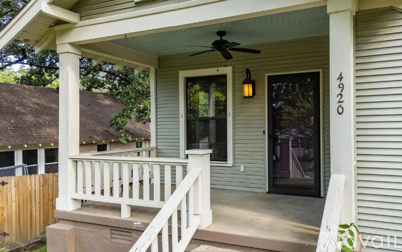 A house numbered 4920 with a porch and a ceiling fan.