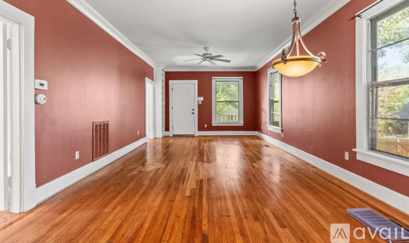 A room with wooden floors and a ceiling fan.