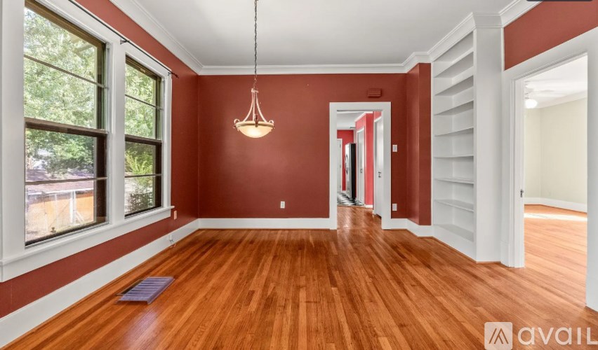 A room with red walls and wooden floors.