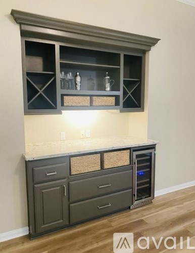 A kitchen with a grey cabinet and a countertop with a basket on it.