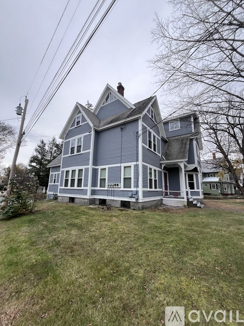 A blue house with a white trim is for sale.