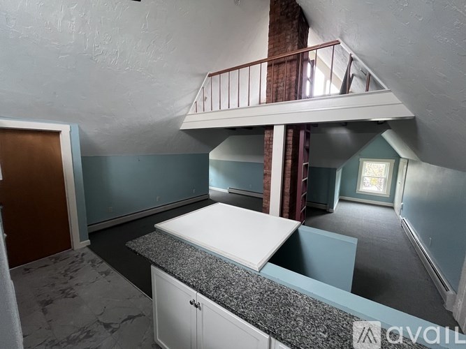 A room with a counter and cabinets is available for rent.