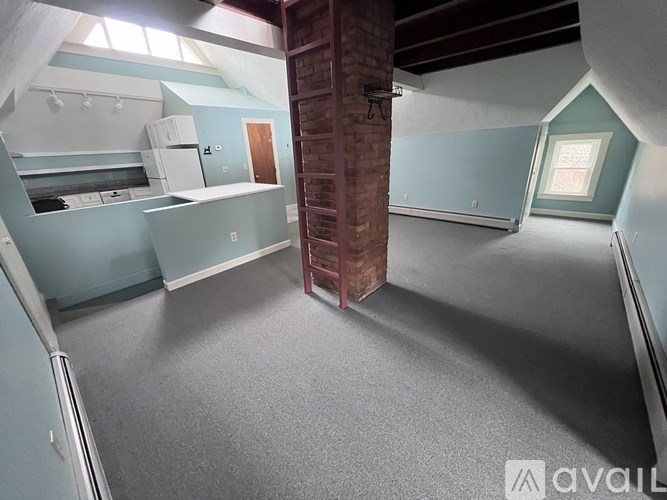 A room with a brick pillar and a window.