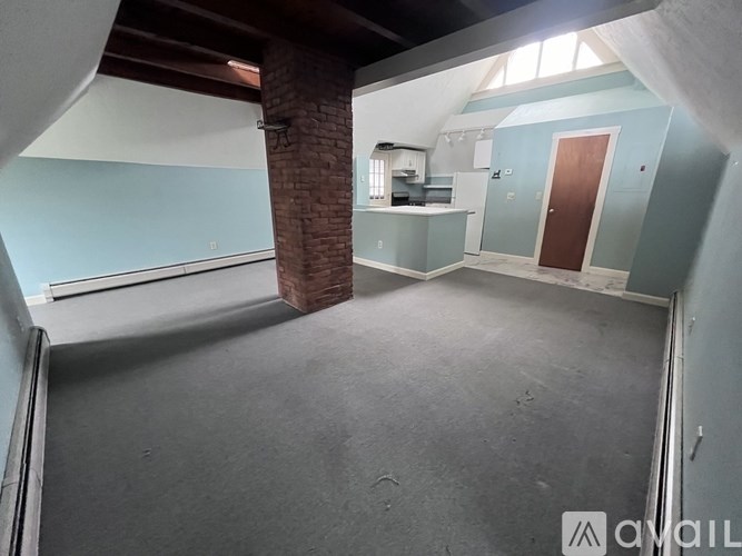 A room with a brick pillar and a door.