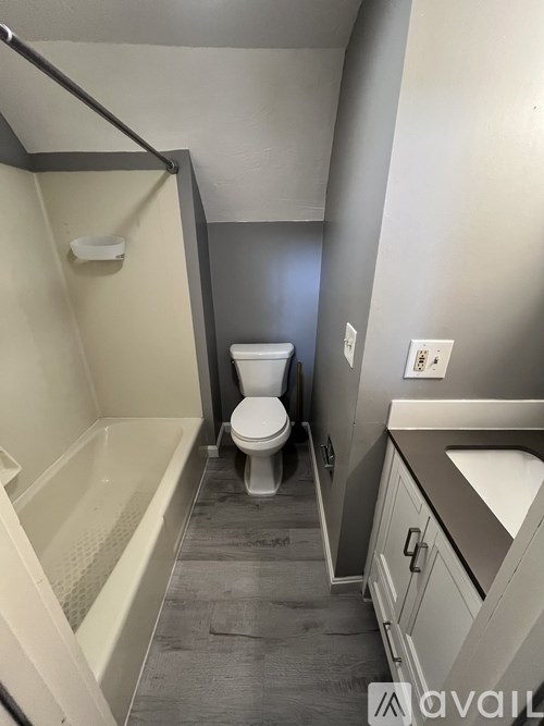 A small bathroom with a toilet and a bathtub.