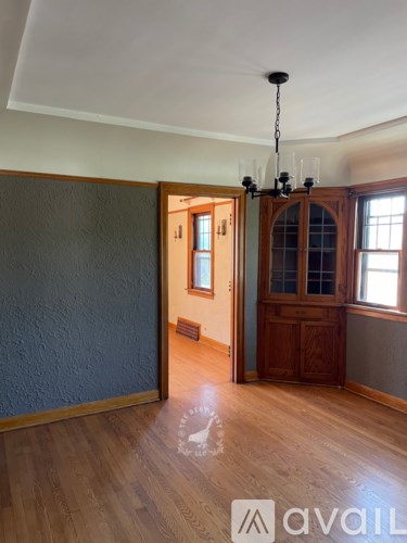 A room with wooden floors and a chandelier.