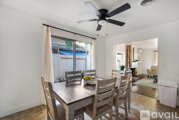 A dining room with a table and chairs is available for rent.