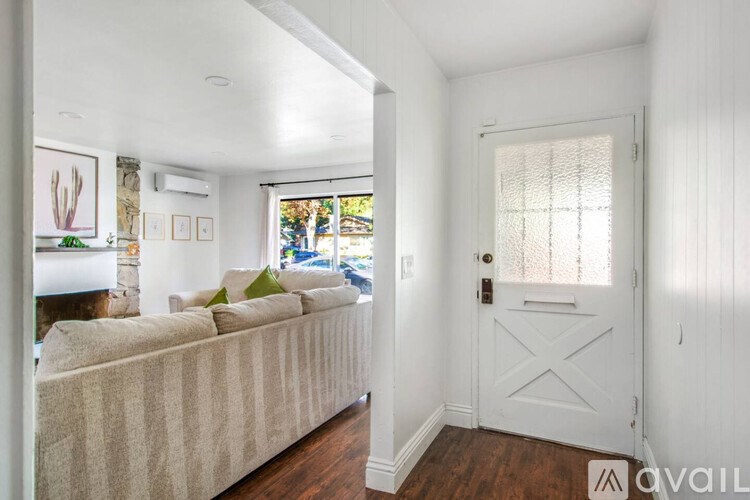 A living room with a couch and a door.