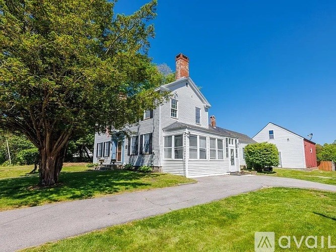 A house with a tree in front of it.