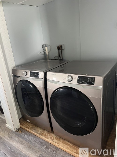 A washing machine and dryer are sitting next to each other.