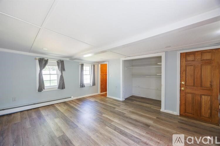 A room with wooden floors and a wooden door.