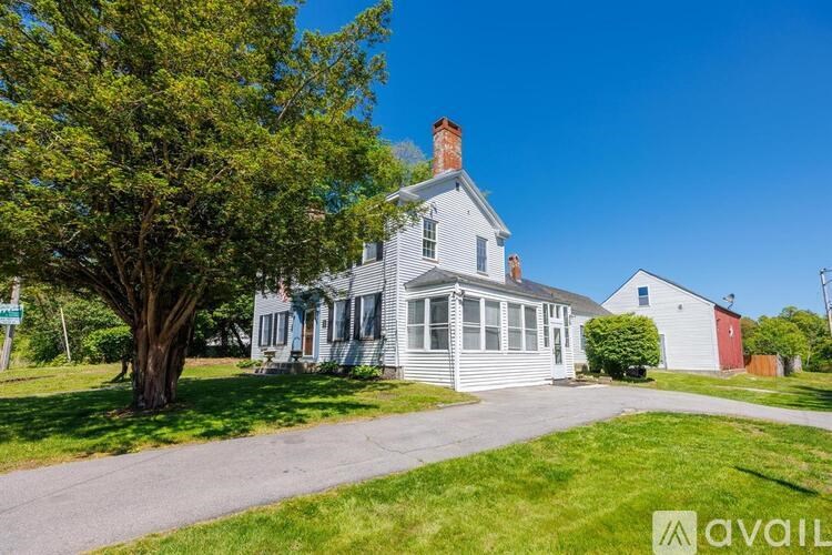 A house with a tree in front of it.