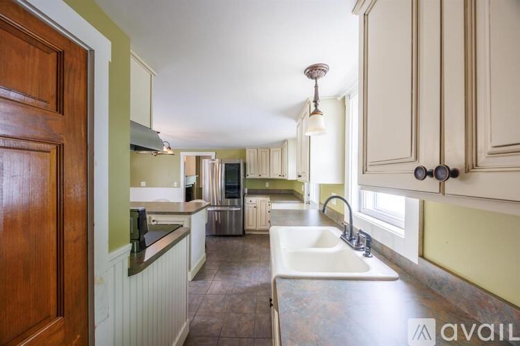 A kitchen with a sink and a window.