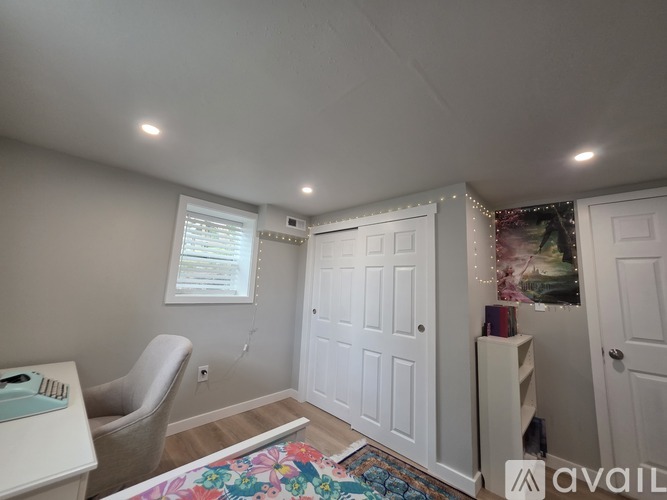 A room with a desk, chair, and a window.