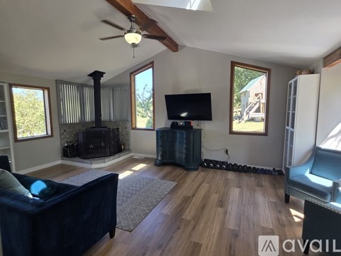 A living room with a dark blue couch and a television.