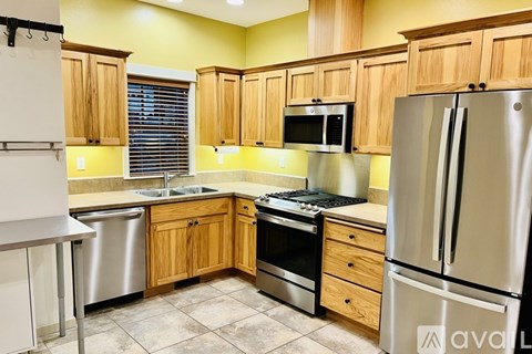 A kitchen with wooden cabinets and stainless steel appliances.