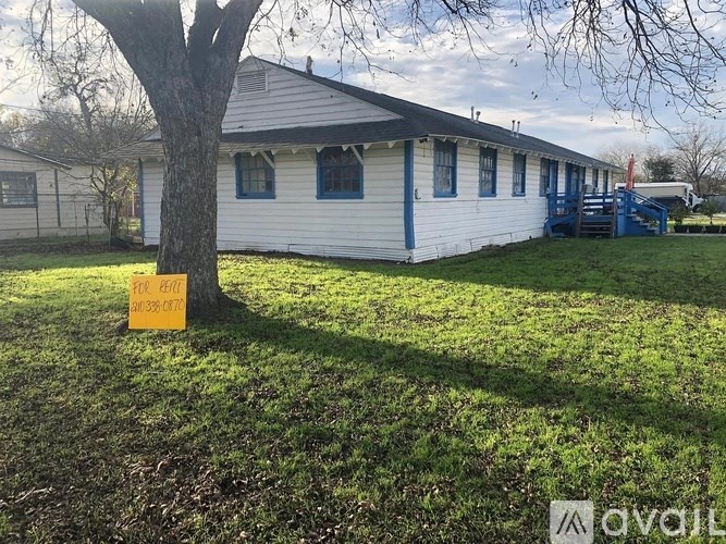 A house with a sign in front of it.