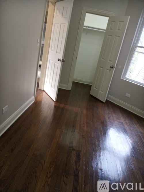 A room with wooden floors and white walls.