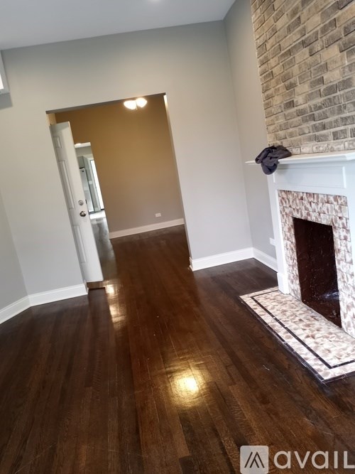 A room with a fireplace and a brick wall.