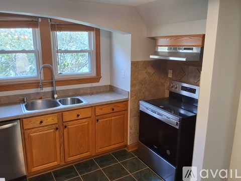 A kitchen with wooden cabinets and a black oven.