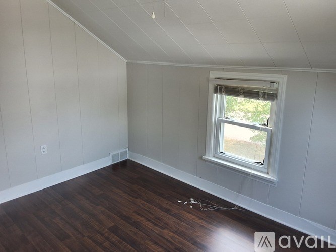 A room with wooden floors and a window.