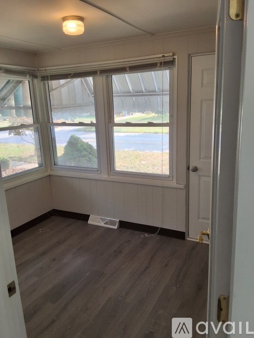 A room with a window and a door.