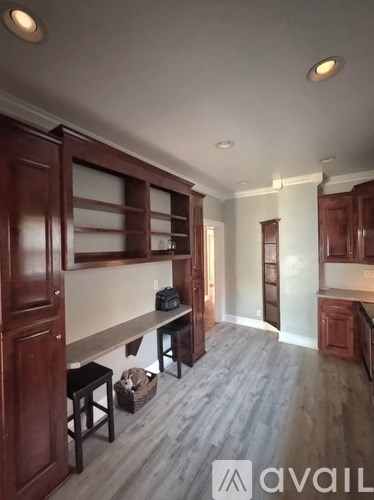 A kitchen with wooden cabinets and a bench.