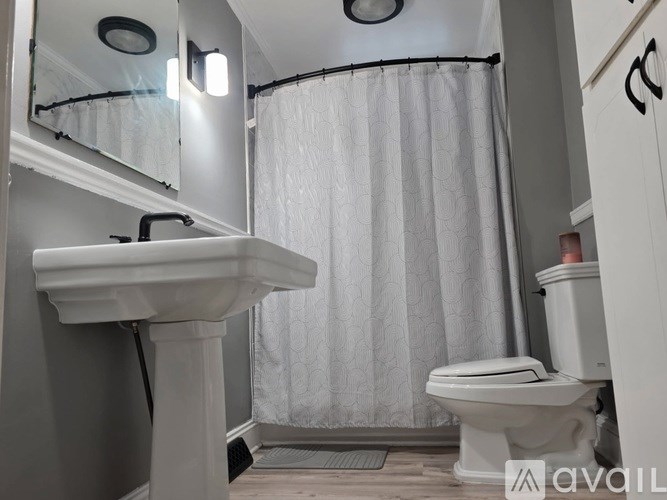 A white sink and toilet in a small bathroom.