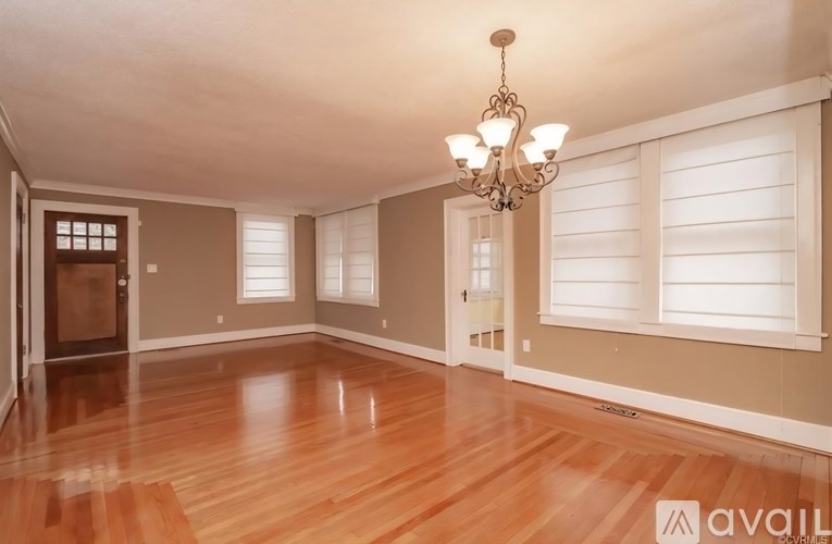 A room with wooden floors and a chandelier.