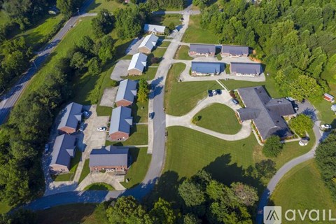 A bird's eye view of a residential area with houses and greenery.