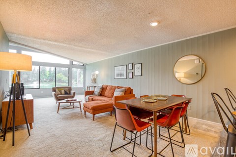 A living room with a dining table and chairs.