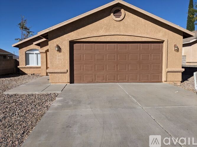 A house with a brown garage door and a driveway.