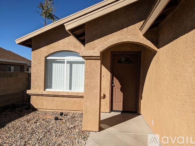 A house with a brown stucco exterior and a brown door.