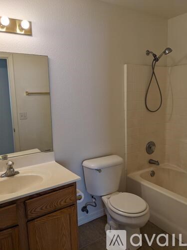 A bathroom with a toilet, sink, and bathtub.