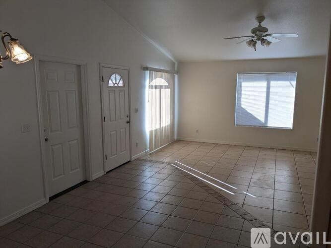 A room with a tiled floor and a ceiling fan.