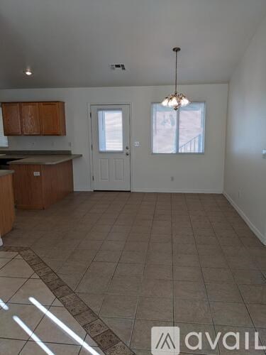 A kitchen with wooden cabinets and a tiled floor.