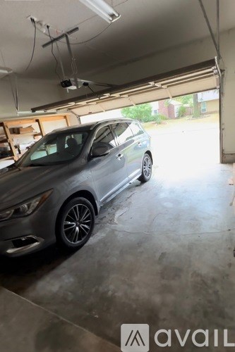 A silver car is parked in a garage.