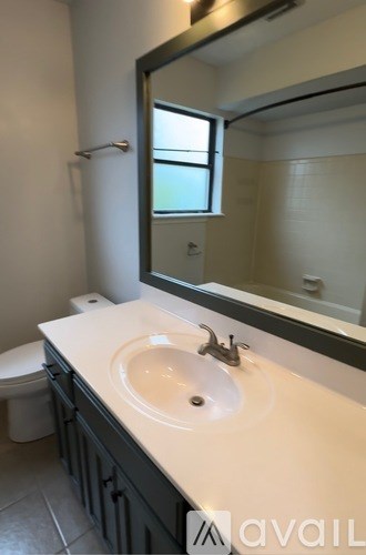 A bathroom with a white sink and a mirror.