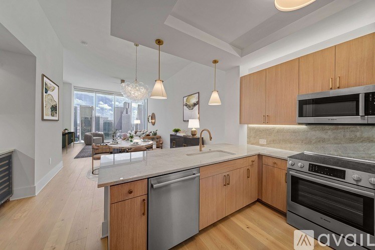 A modern kitchen with wooden cabinets and stainless steel appliances.