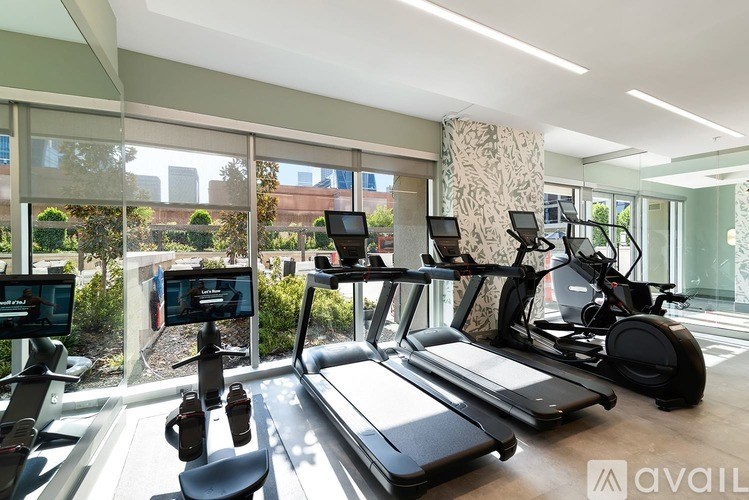 A gym with treadmills, exercise bikes, and other equipment.