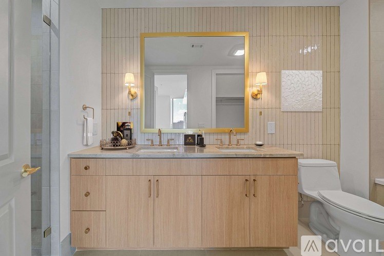 A bathroom with a wooden vanity and a mirror above it.