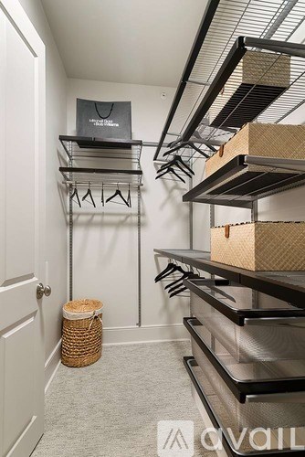 A storage room with shelves and a basket on the floor.