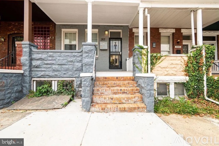 A house with a front porch and a black door.