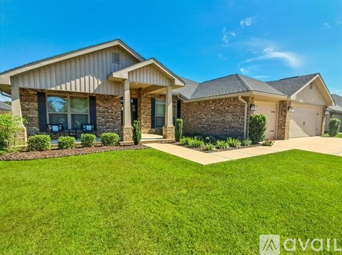 A house with a well-maintained lawn and a clear sky above.