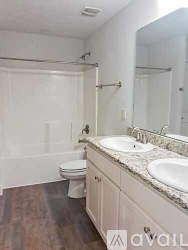A bathroom with a toilet, sink, and bathtub.
